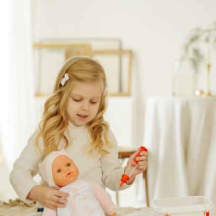 girl playing with baby doll